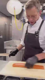 Video waarop een verse koud gerookte zalmhaas professioneel wordt gesneden voor servering.